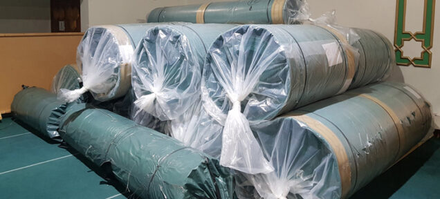Rolls of new green carpet to be used in Mosque renovations