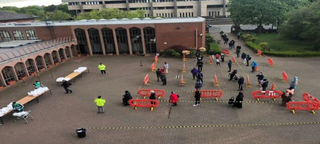 Exterior queue of people for Ramadan food service